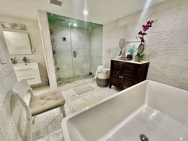 bathroom featuring vanity, tile floors, and separate shower and tub