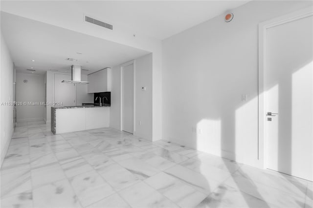 unfurnished living room featuring light tile floors