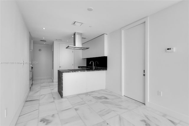 kitchen featuring light tile flooring, white cabinets, and island range hood