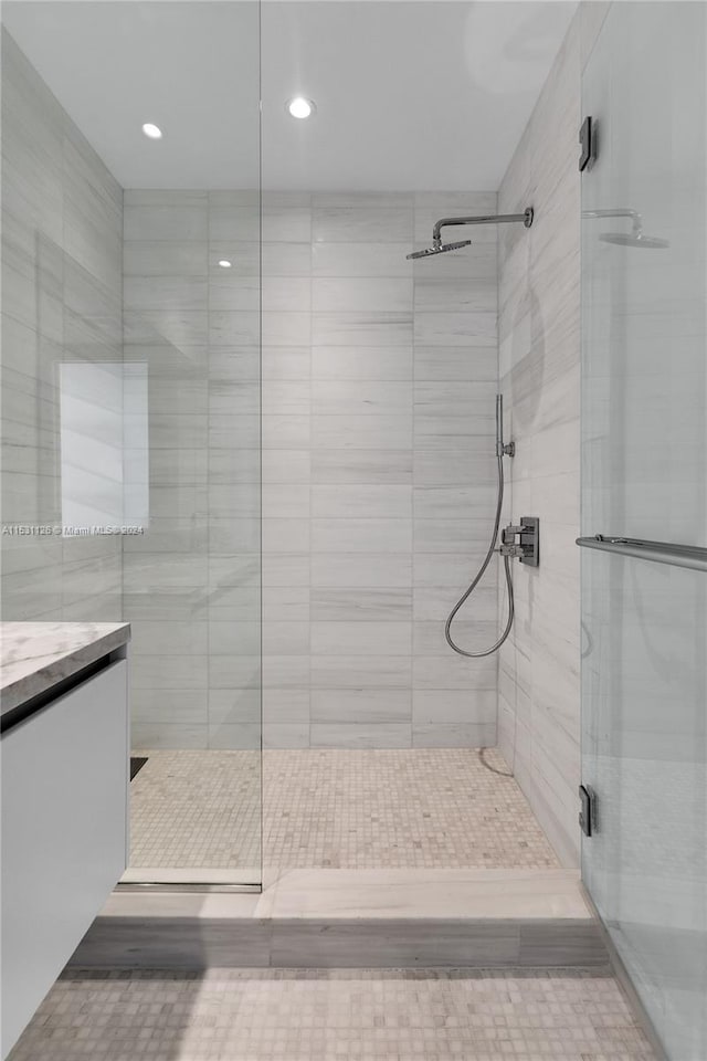 bathroom with vanity and a shower with shower door