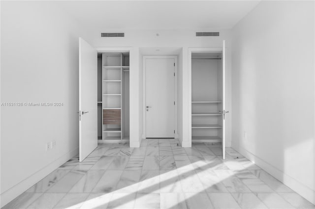 unfurnished bedroom featuring a closet and light tile flooring