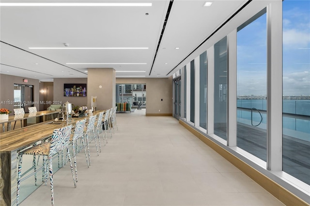 tiled dining room featuring a water view