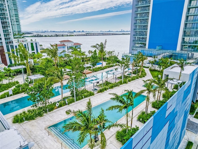 balcony featuring a community pool and a water view