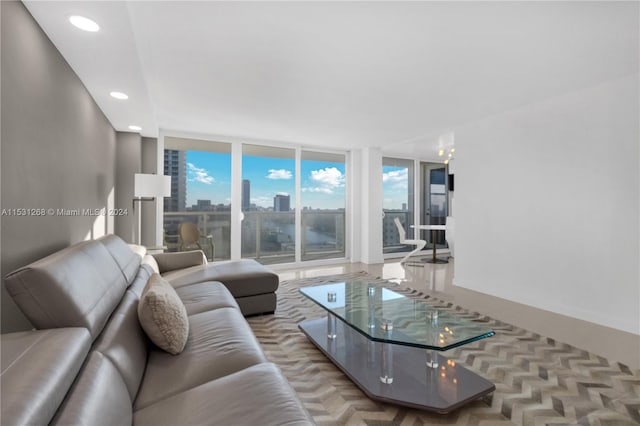 living room with a wall of windows and parquet flooring