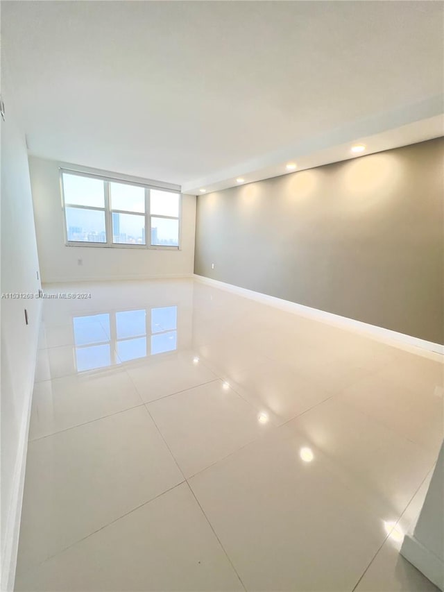 unfurnished room featuring tile floors