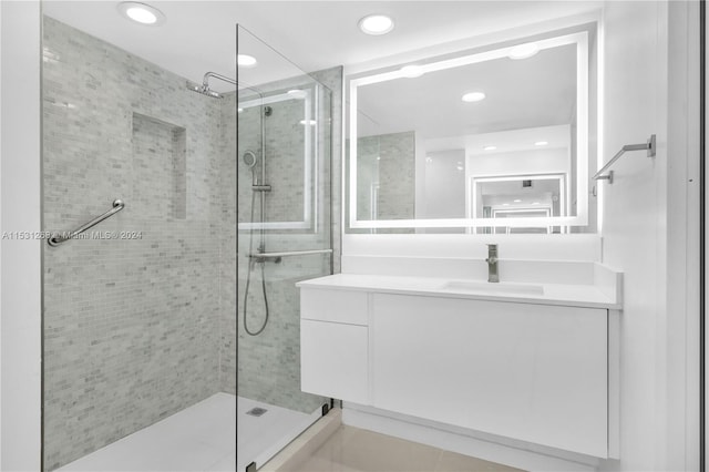 bathroom featuring tile floors, an enclosed shower, and vanity