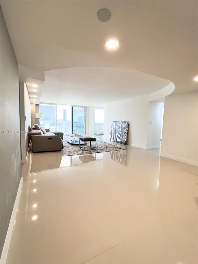 unfurnished living room featuring a wall of windows