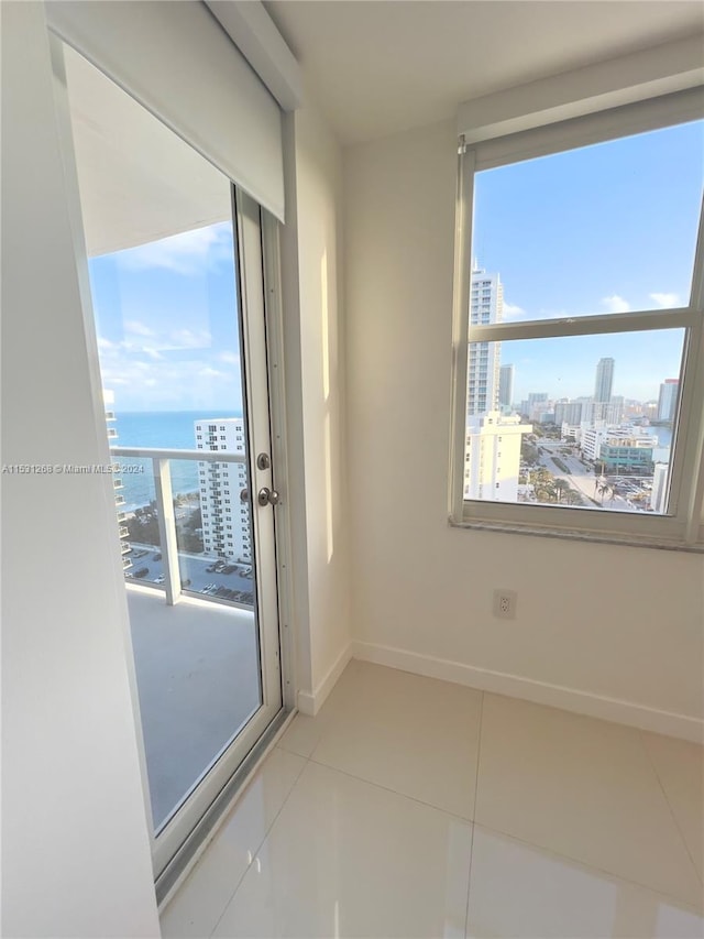 tiled empty room with a water view