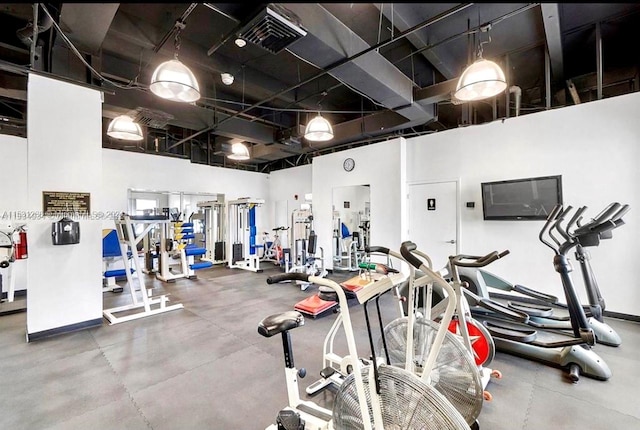 workout area with a high ceiling