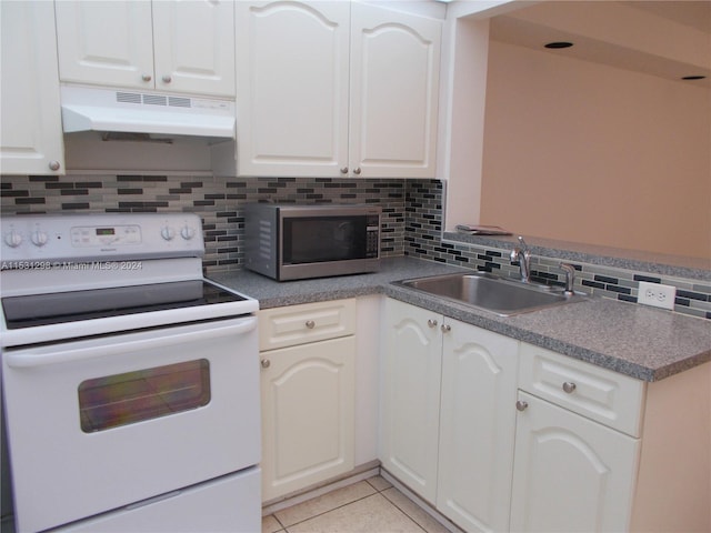 kitchen with light tile patterned flooring, sink, white cabinetry, and white range with electric stovetop