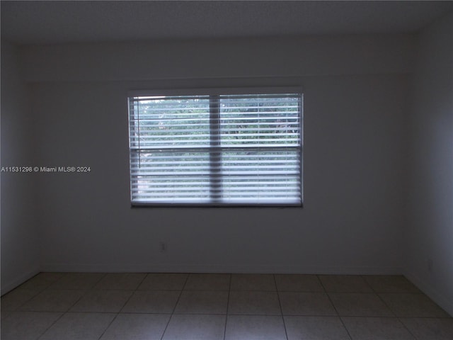 spare room with tile patterned flooring