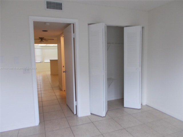 unfurnished bedroom with a closet and light tile patterned floors