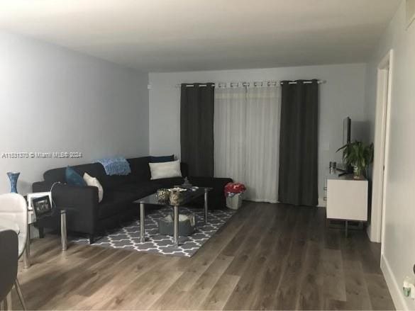 living room with dark wood-type flooring