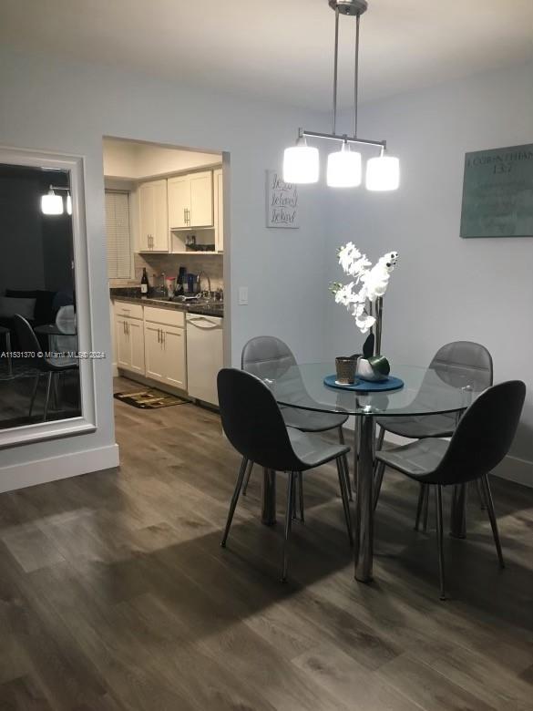 dining room with a notable chandelier and dark hardwood / wood-style flooring