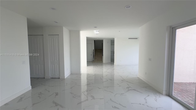 unfurnished room featuring light tile flooring