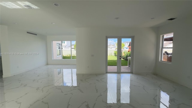 tiled empty room featuring a wealth of natural light