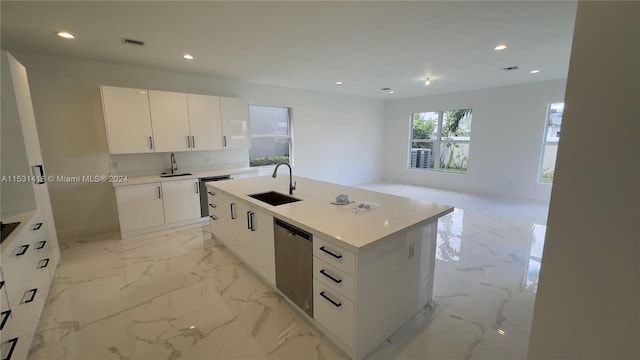 kitchen with sink, a center island with sink, white cabinetry, and light tile floors