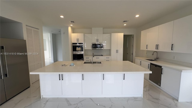 kitchen featuring stainless steel appliances, a large island, sink, and light tile floors