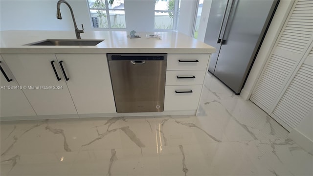 kitchen with white cabinetry, sink, and stainless steel appliances