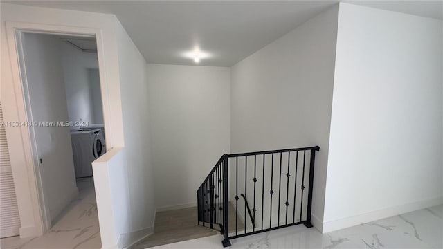 staircase featuring separate washer and dryer