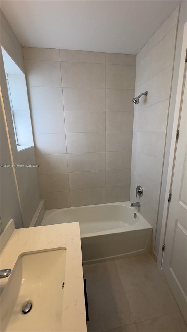 bathroom with tile flooring, vanity, and tiled shower / bath combo