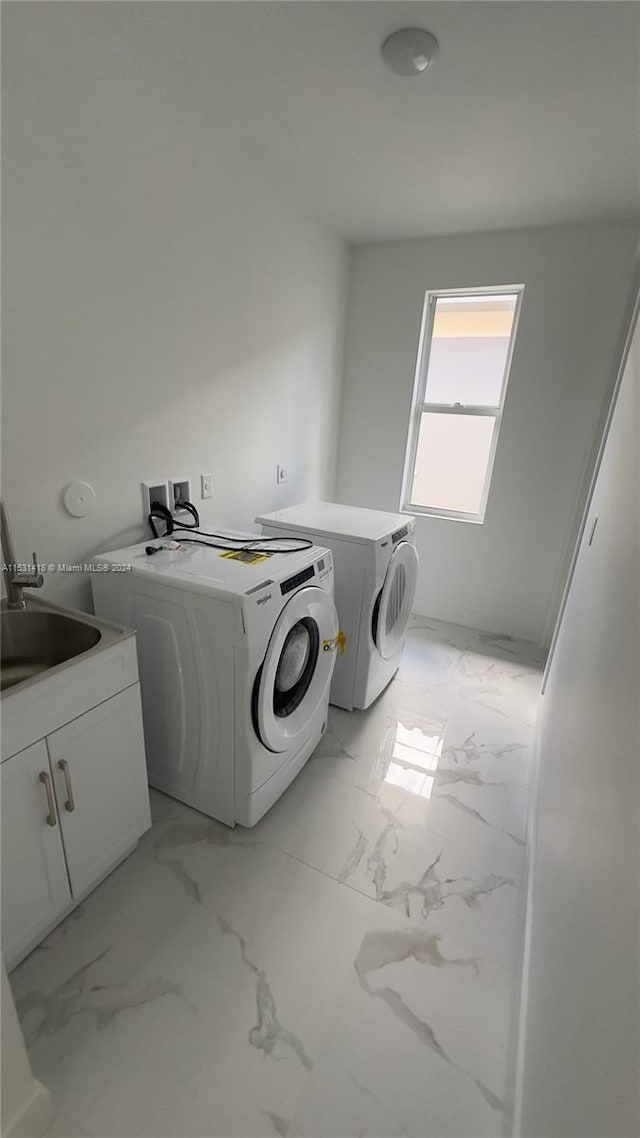 clothes washing area with separate washer and dryer, cabinets, washer hookup, sink, and light tile floors