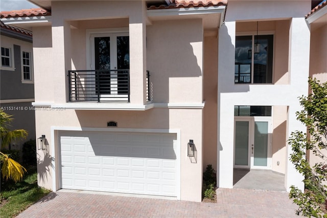 view of front of property with a garage and a balcony