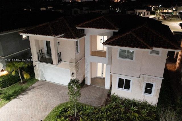 view of front of house with a garage and a balcony