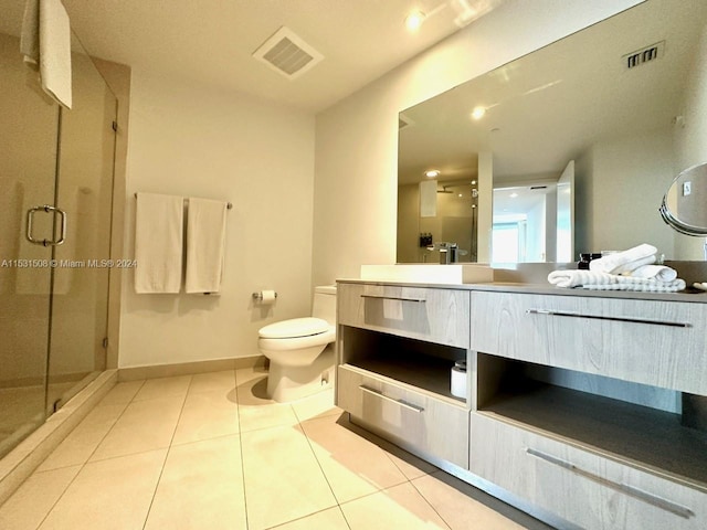 bathroom featuring large vanity, tile flooring, an enclosed shower, and toilet