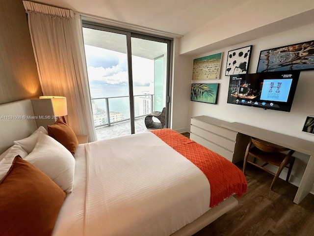 bedroom with access to outside, expansive windows, and dark wood-type flooring