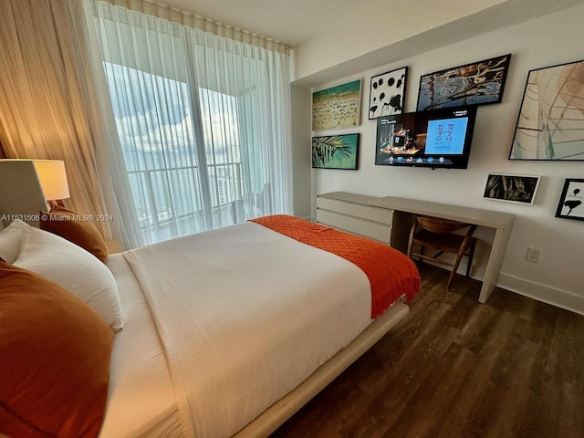 bedroom with dark hardwood / wood-style flooring