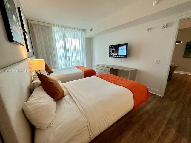 bedroom featuring dark hardwood / wood-style flooring