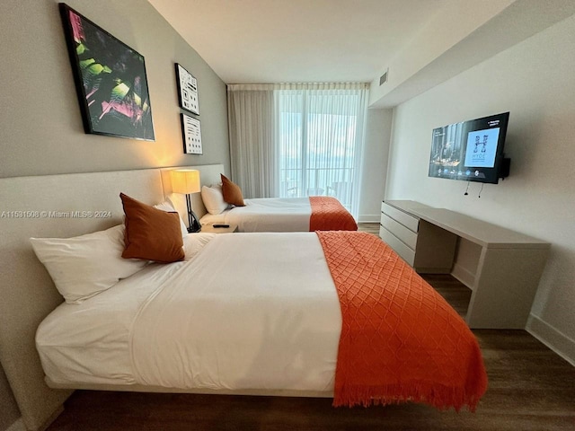 bedroom with dark wood-type flooring