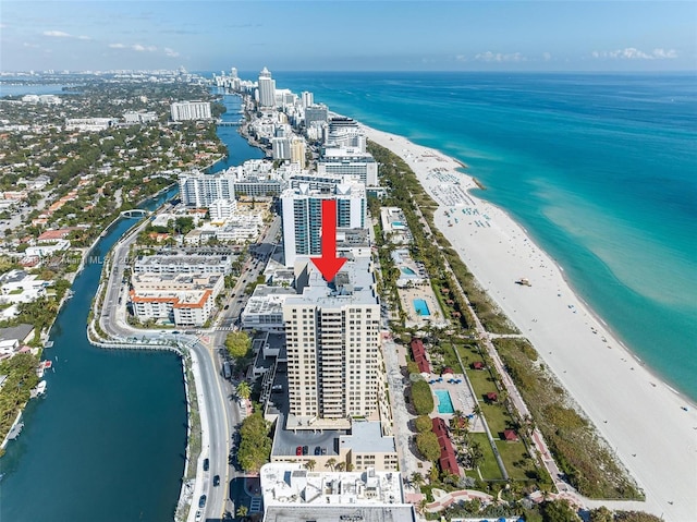 bird's eye view with a water view and a view of the beach