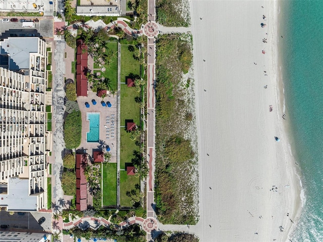 aerial view with a water view and a beach view