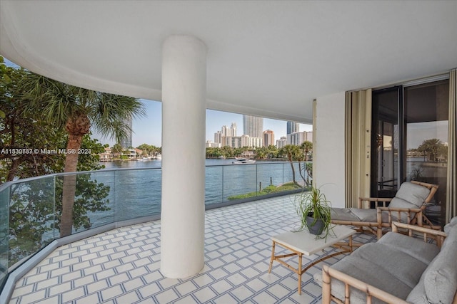 view of terrace featuring a balcony and a water view