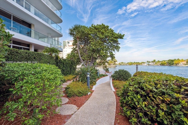 view of yard featuring a balcony and a water view