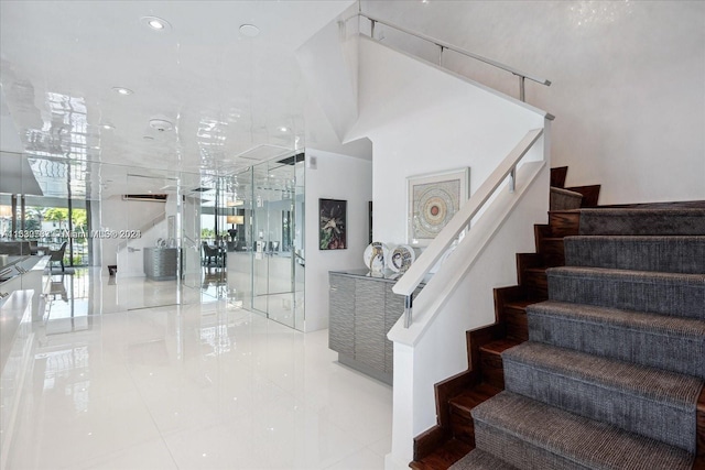 staircase with light tile floors