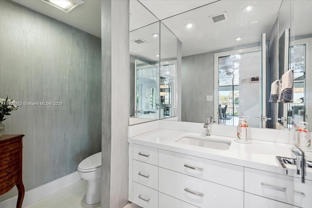 bathroom featuring tile floors, toilet, and vanity