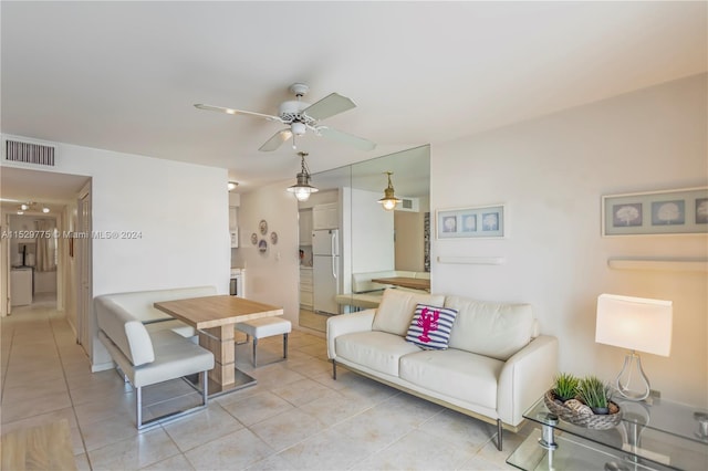 living room with light tile floors and ceiling fan