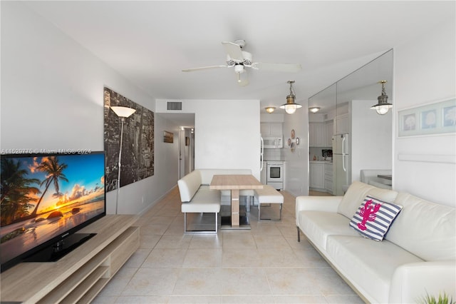 tiled living room with ceiling fan