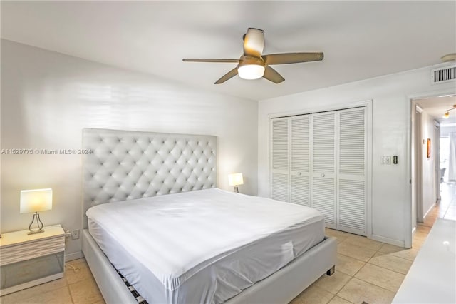 bedroom featuring light tile flooring, a closet, and ceiling fan