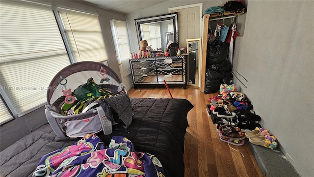 bedroom with vaulted ceiling and light wood-type flooring