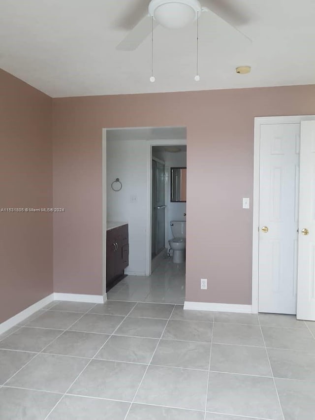 tiled empty room with ceiling fan