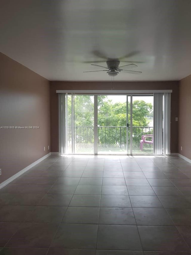 tiled spare room with ceiling fan and a wealth of natural light