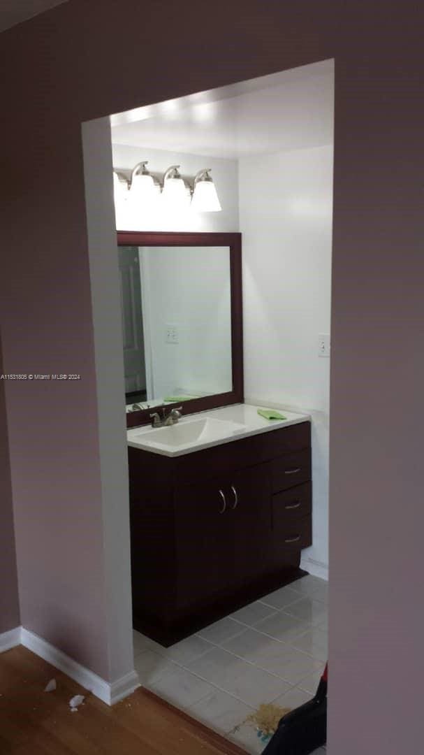 bathroom featuring vanity and wood-type flooring