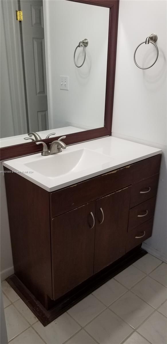 bathroom with vanity and tile flooring