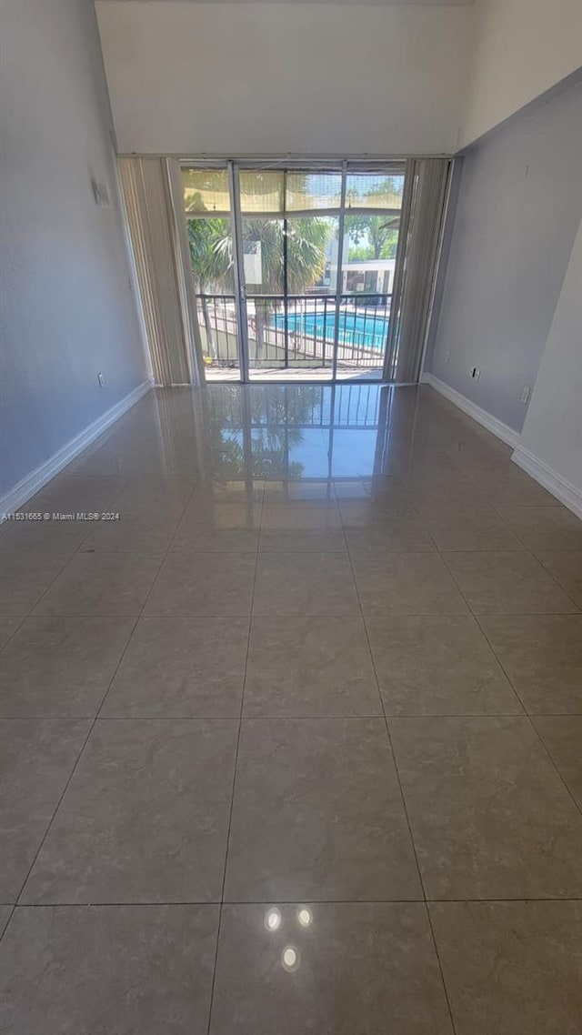 tiled empty room with a wealth of natural light