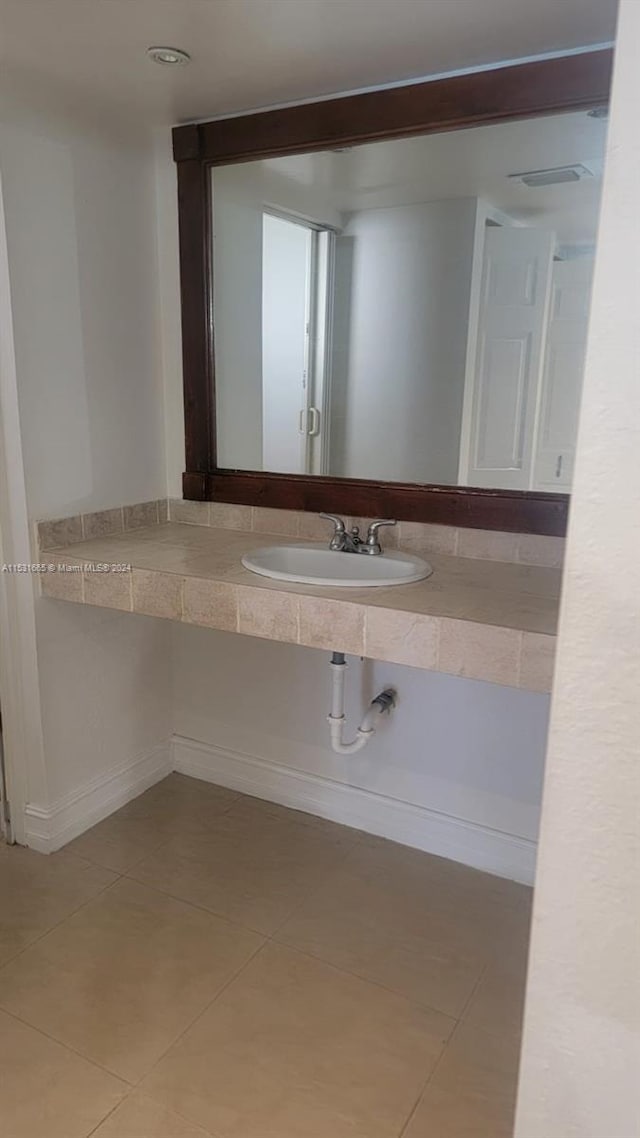 bathroom with sink and tile floors