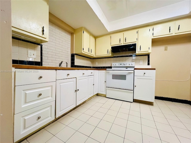 kitchen with tasteful backsplash, electric range, and light tile patterned floors